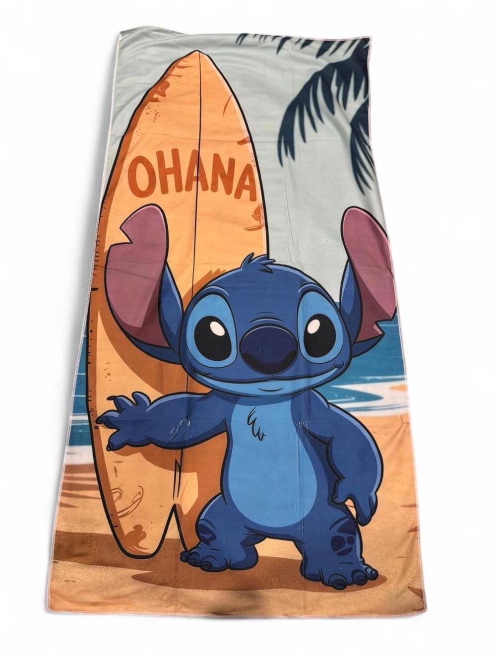 Stitch beach towel with Stitch holding a surfboard with the word 'OHANA'
